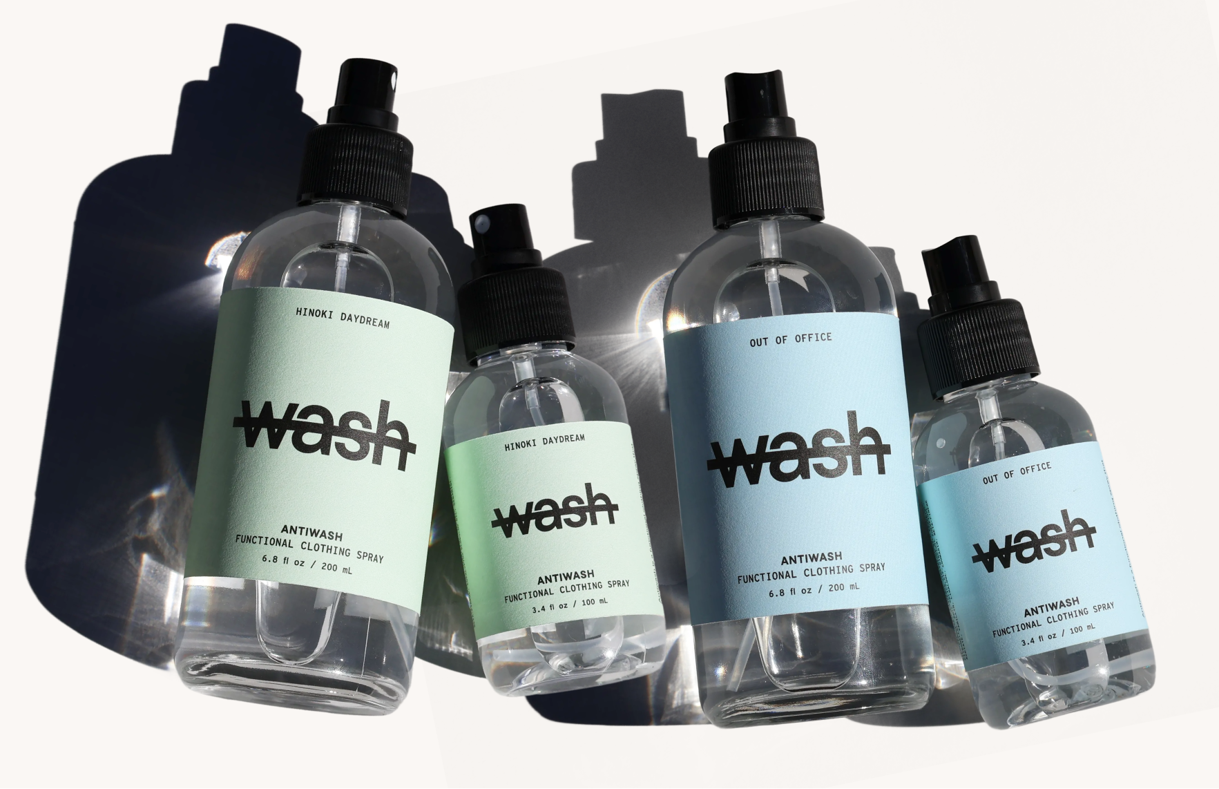 Five bottles of 'wash' antiseptic spray on a white background