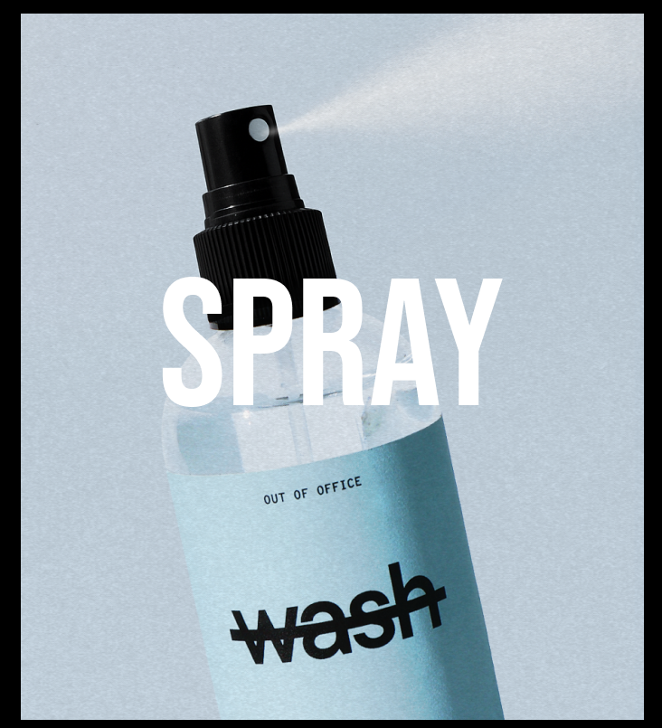 A bottle of WASH Out of Office room spray with a black pump nozzle spraying a fine mist, set against a textured light blue-gray background with a bold white 'SPRAY' text overlay.